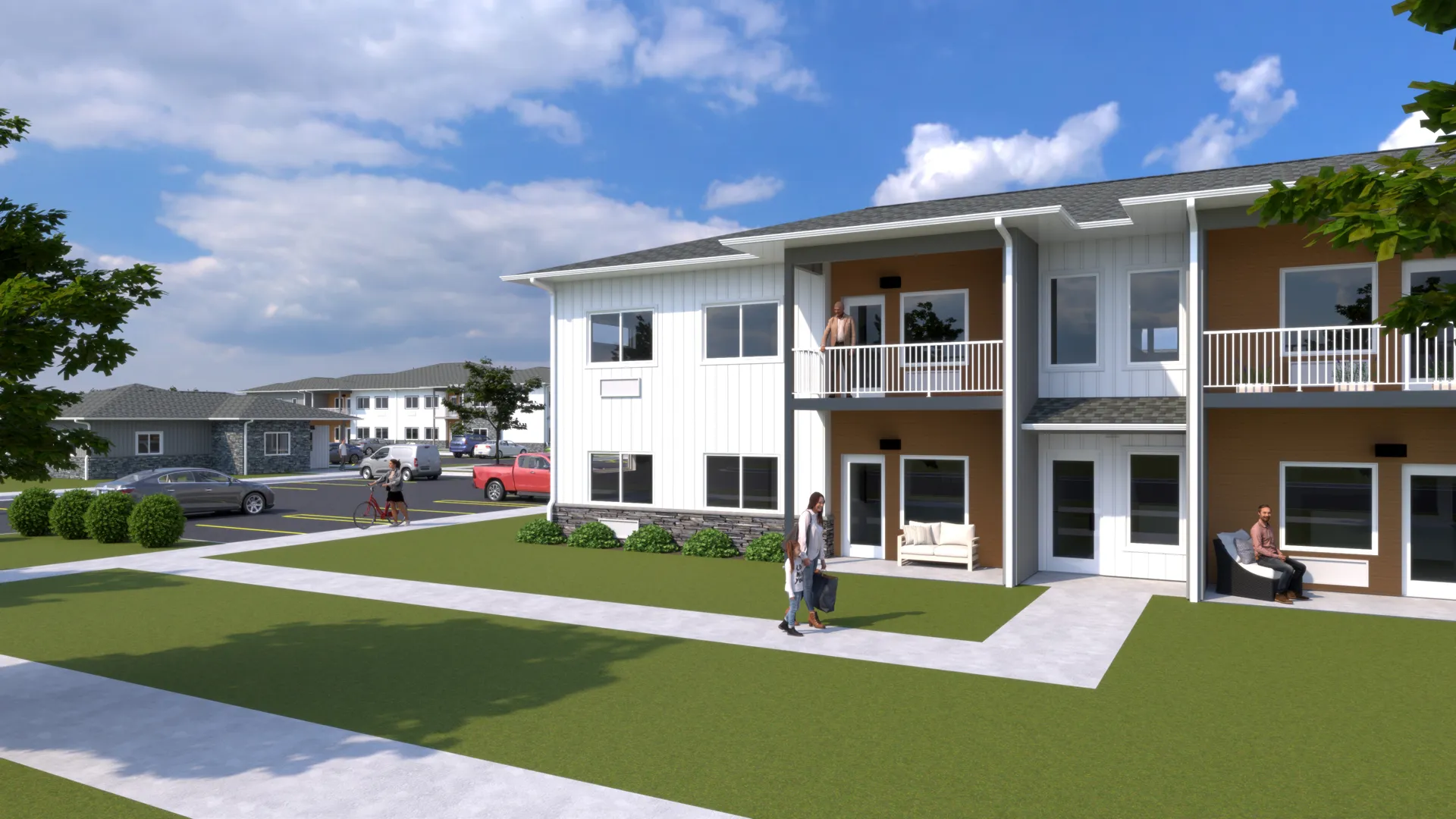 Contemporary apartment building with balconies and green lawn in a suburban setting.