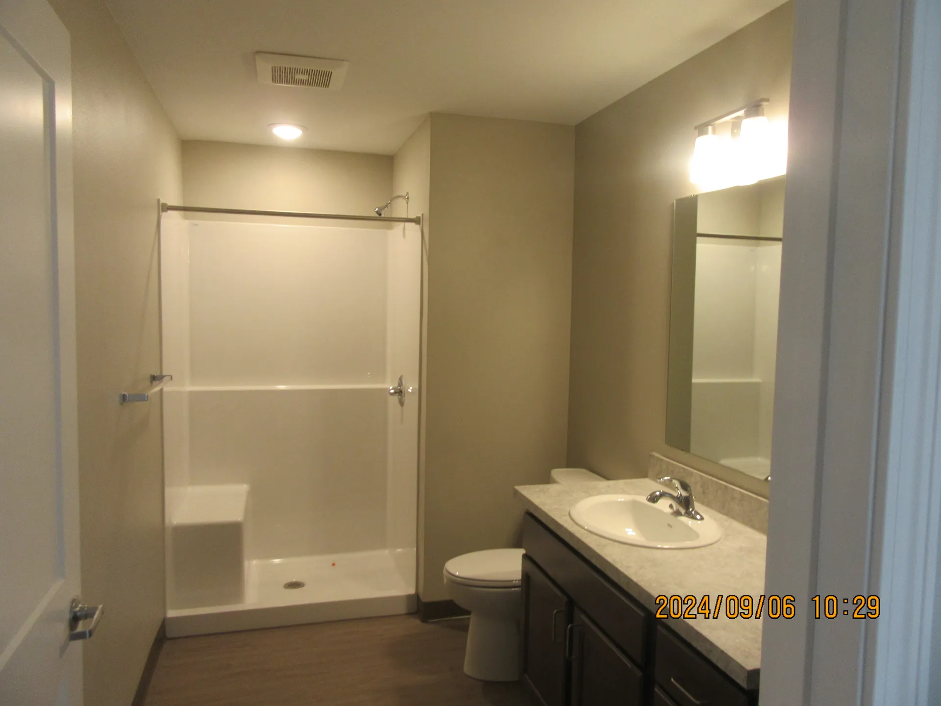 Bathroom renovation with walk-in shower and vanity.