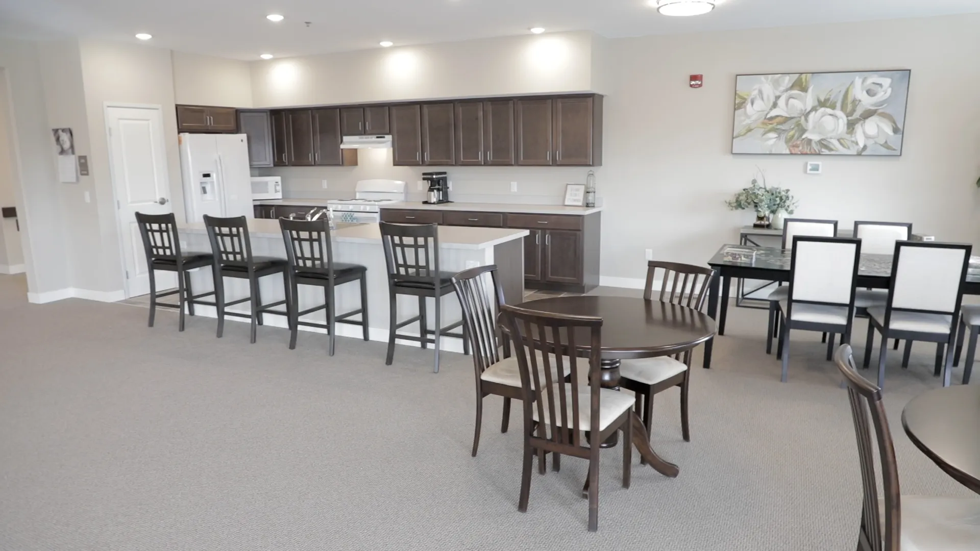 Modern kitchen and dining space with stylish furniture and cabinetry.