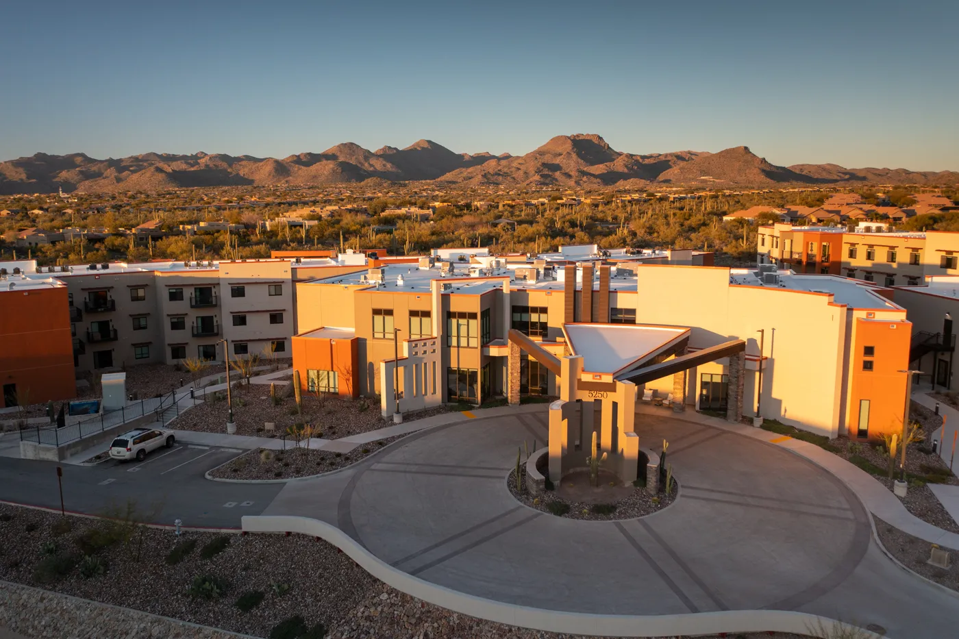 Modern residential complex with mountain views and contemporary architecture.