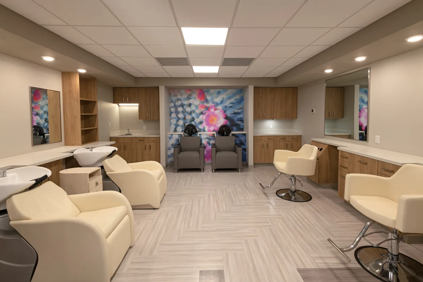 Modern medical treatment room with comfortable chairs and calming artwork for patient comfort.