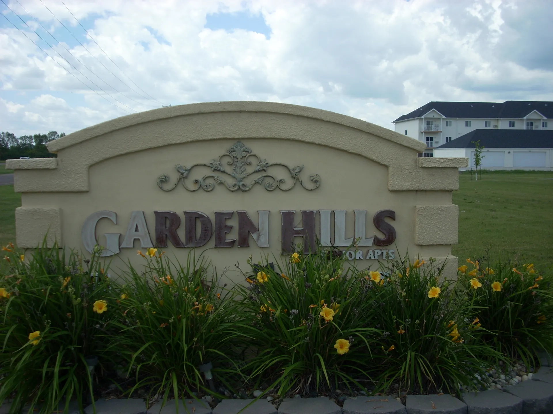 Entrance sign for Garden Hills residential community with landscaping.