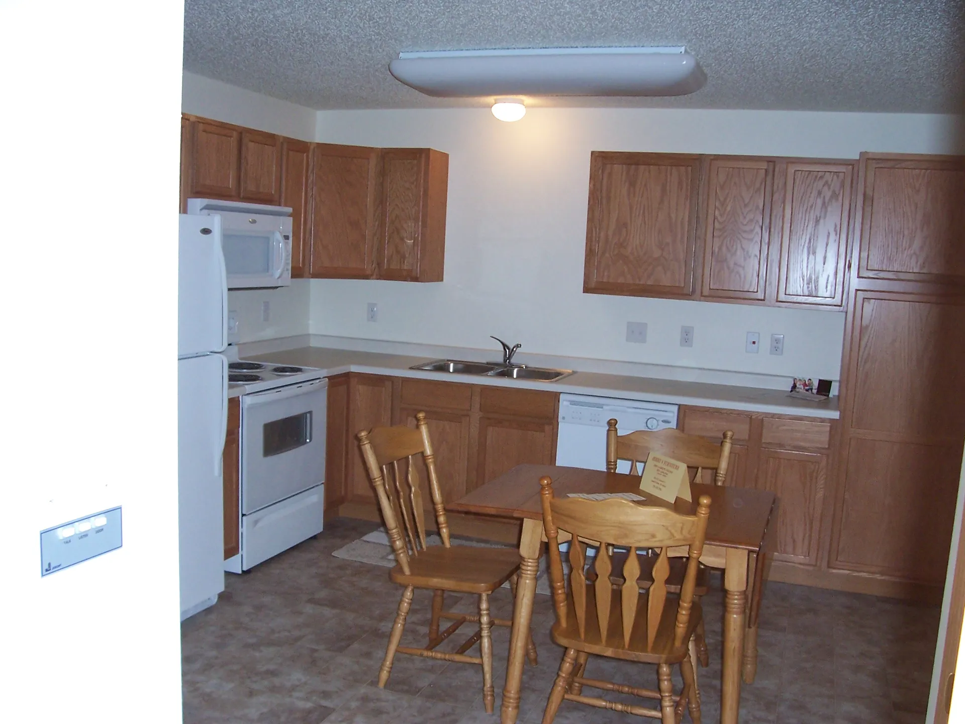 Kitchen renovation with wooden cabinets and modern appliances.