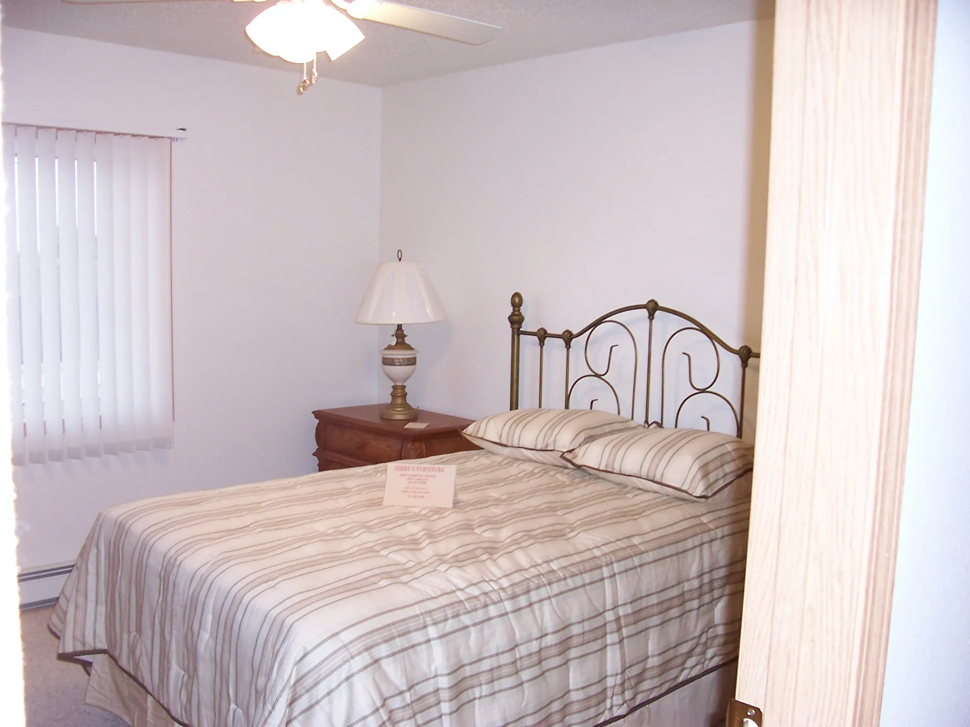 Modern bedroom with metal bed frame and wooden nightstand for a cozy home.