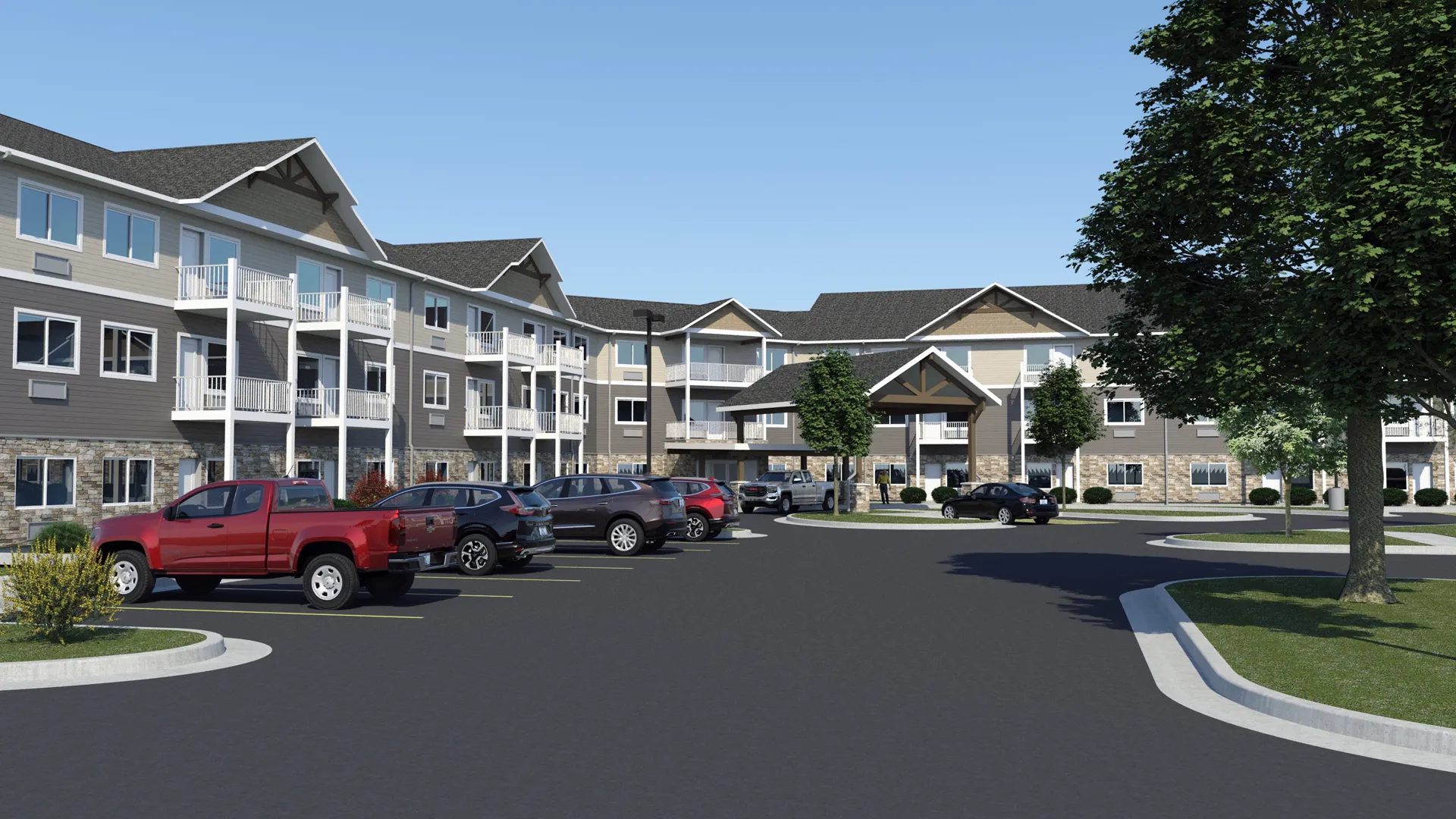 Apartment complex with parking lot and landscaped greenery in a suburban setting.
