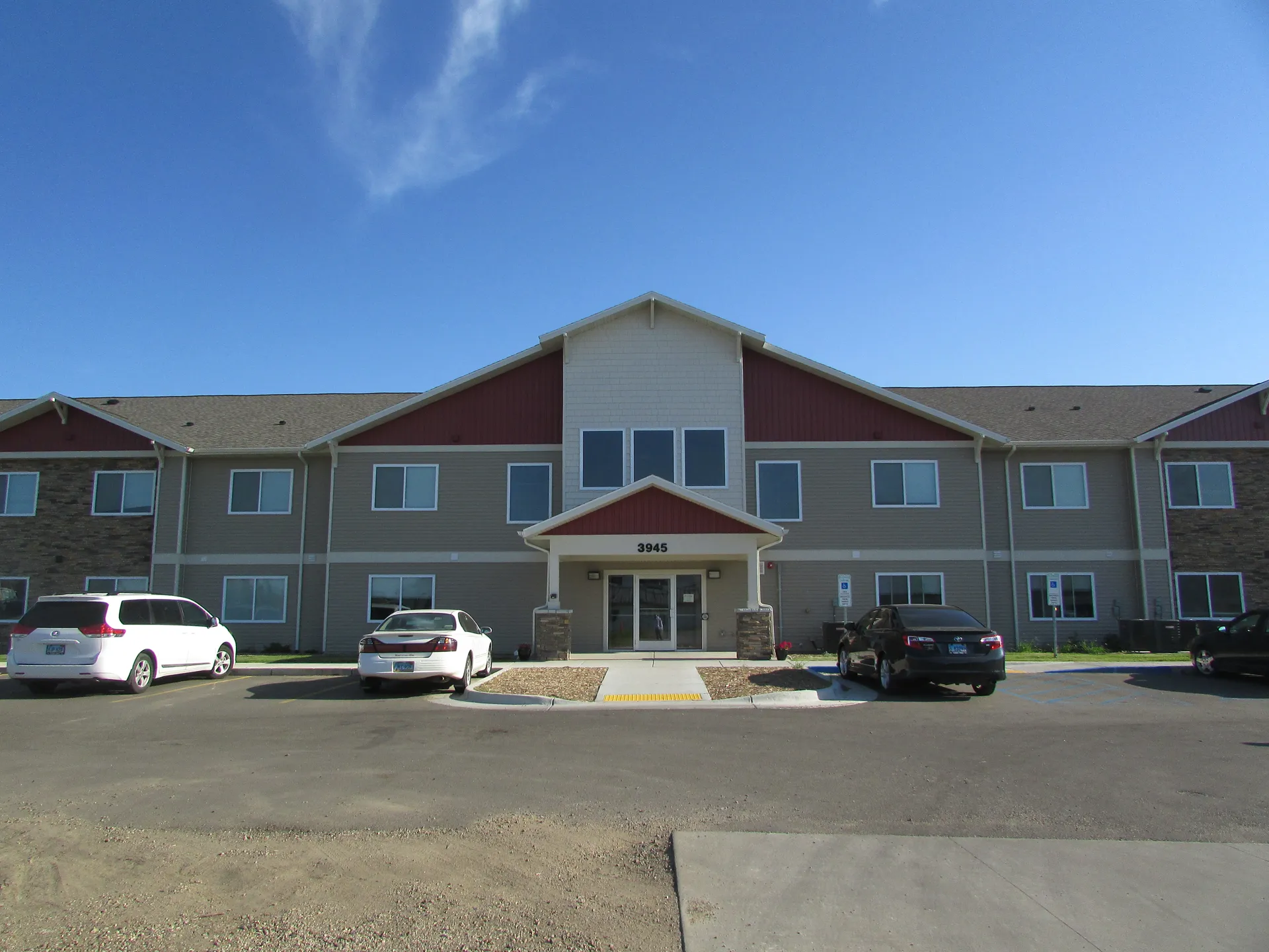 Apartment complex with multiple units and parking area.