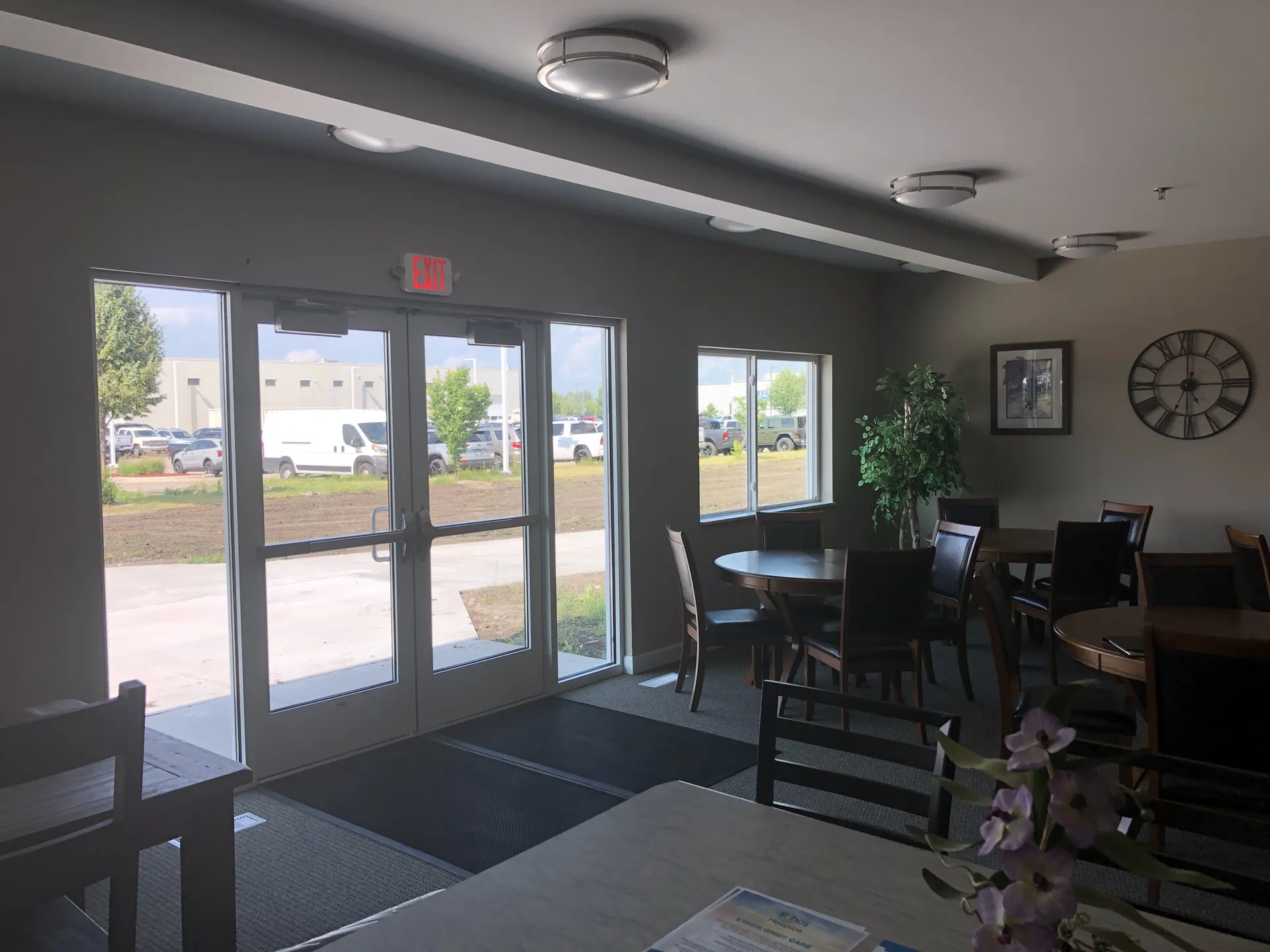 Interior dining space with large glass doors and natural light.