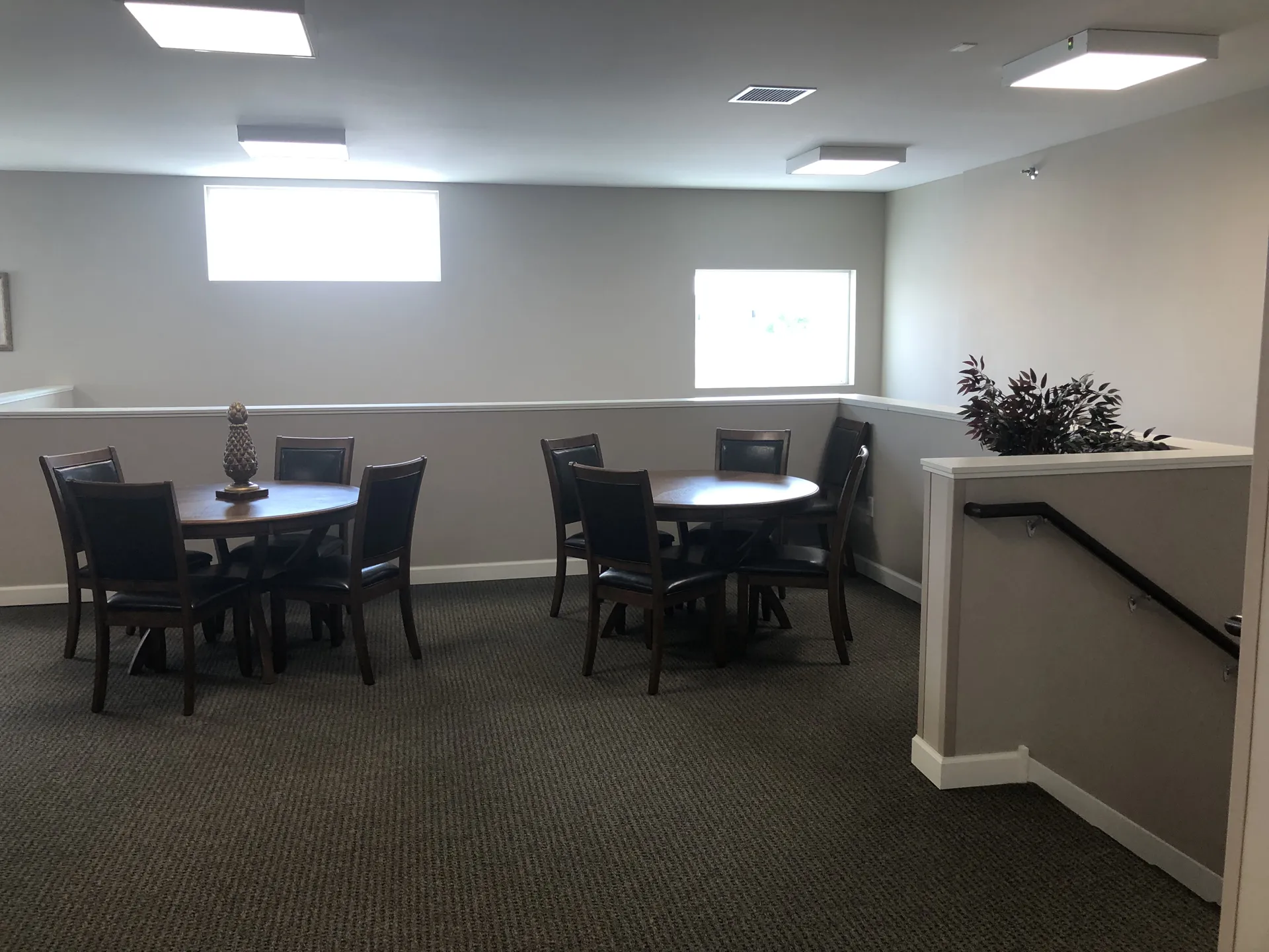 Comfortable office lounge with tables and chairs for meetings or breaks.