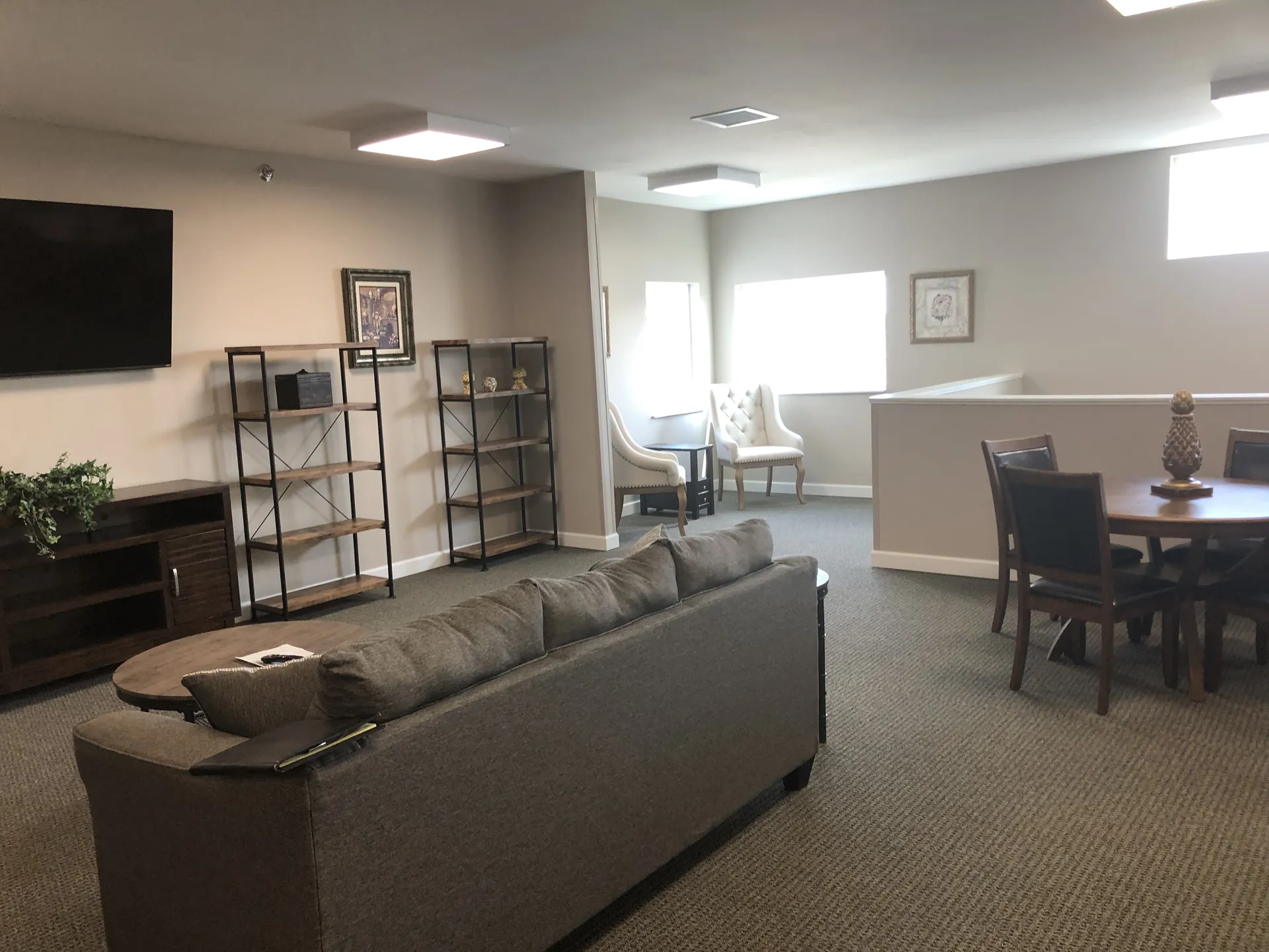 Spacious living room featuring a sofa, chairs, and entertainment area for relaxation.