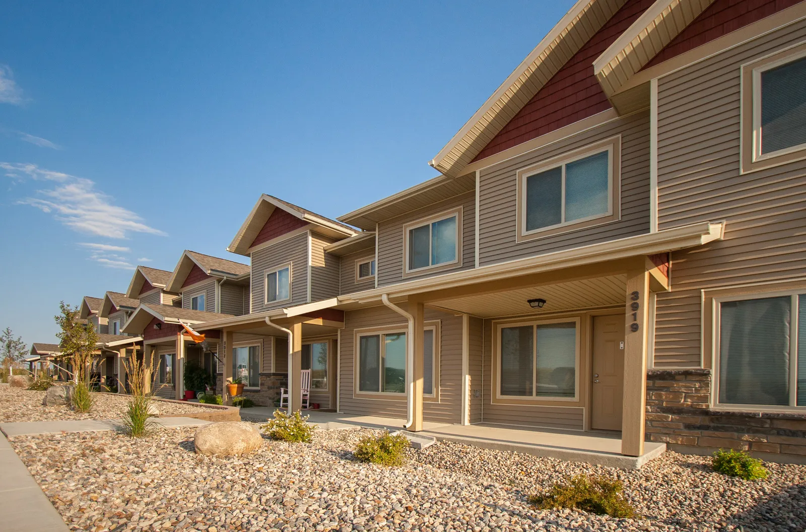 Contemporary multi-family housing with modern design and landscaping.