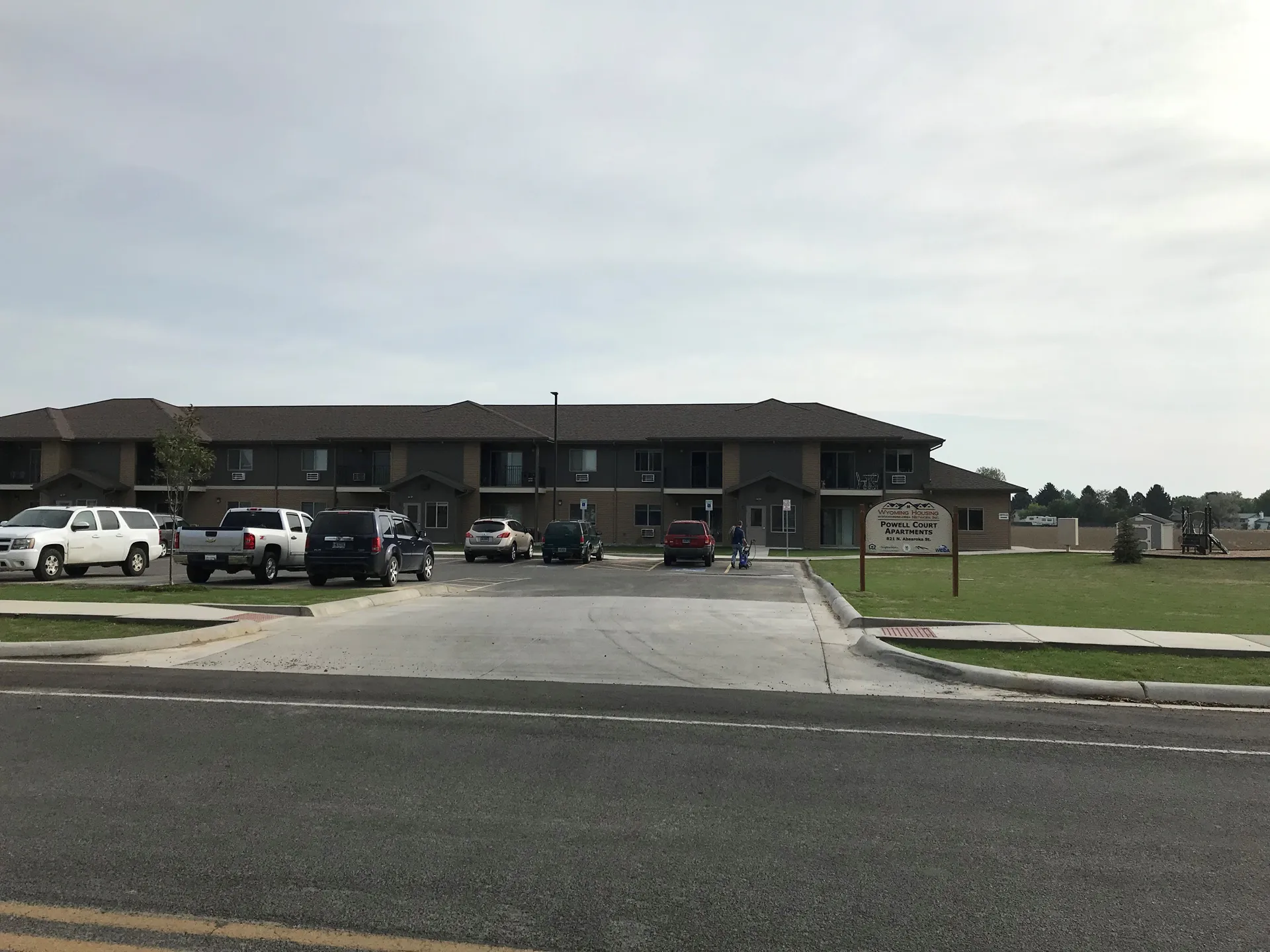 Commercial office building with parking lot and landscaped surroundings.