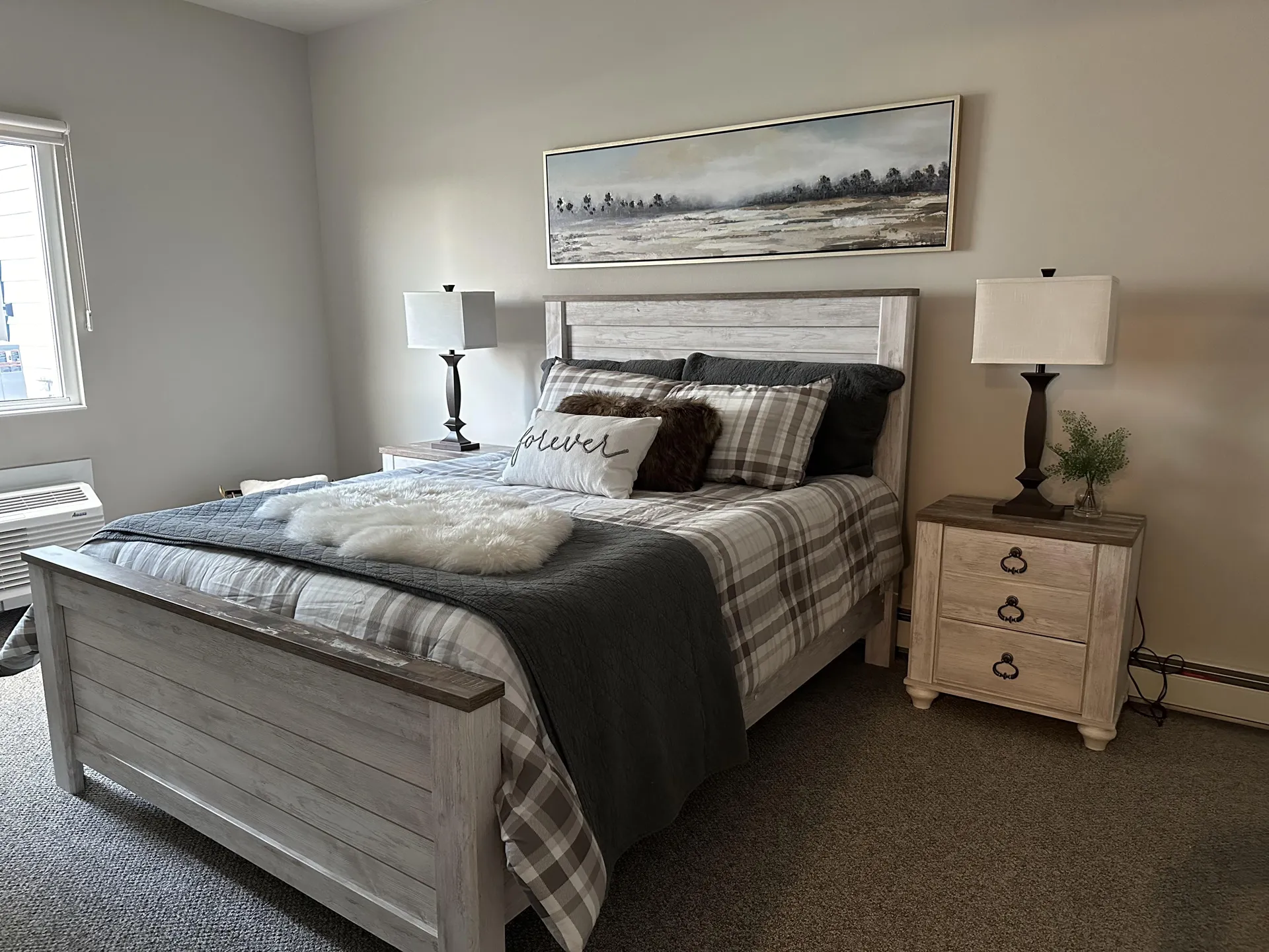 Cozy bedroom featuring a stylish bed, matching nightstands, and soft lighting for a relaxing atmosph.