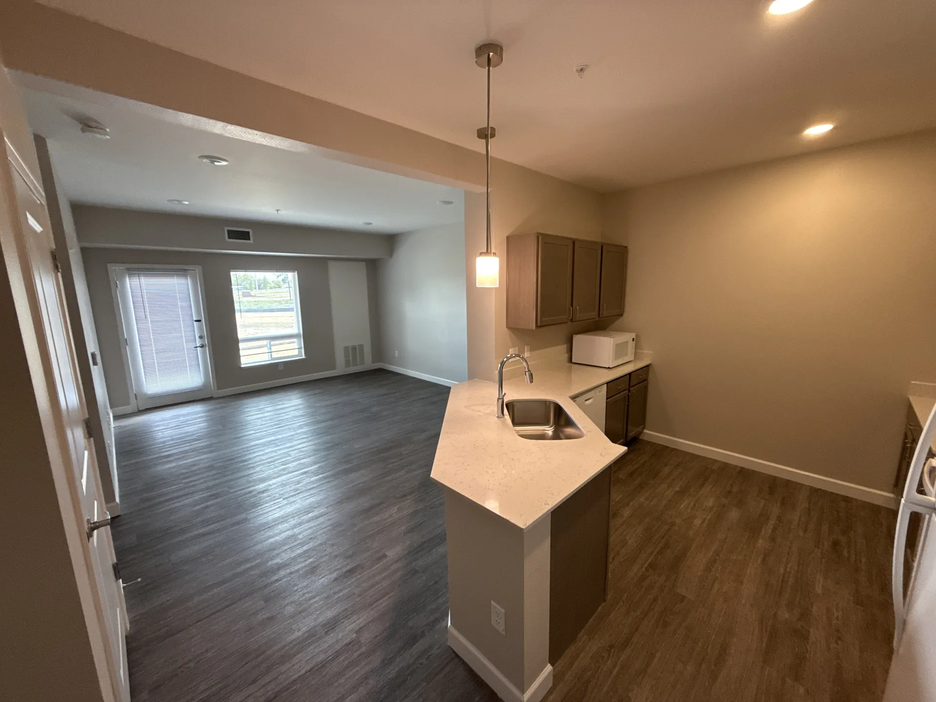 Spacious living room with large windows and natural light.
