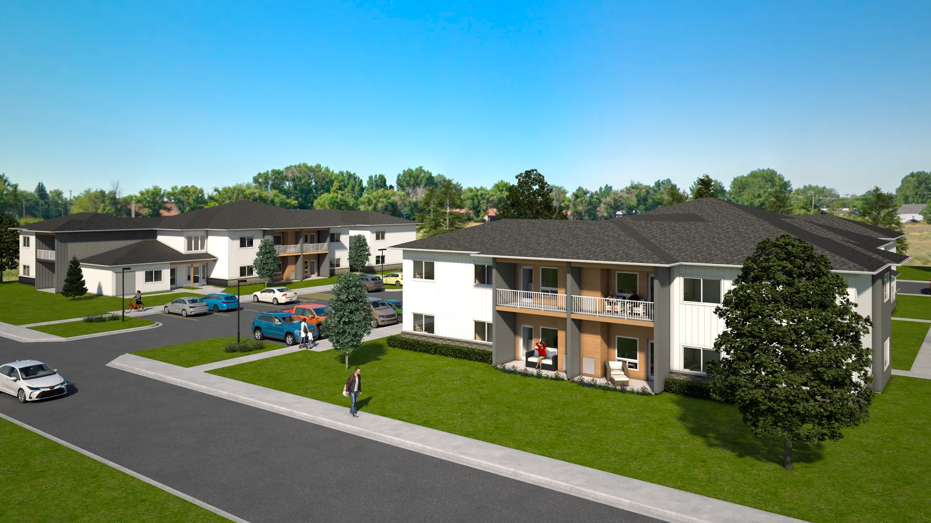 New residential apartment complex with landscaped lawns and parking spaces.