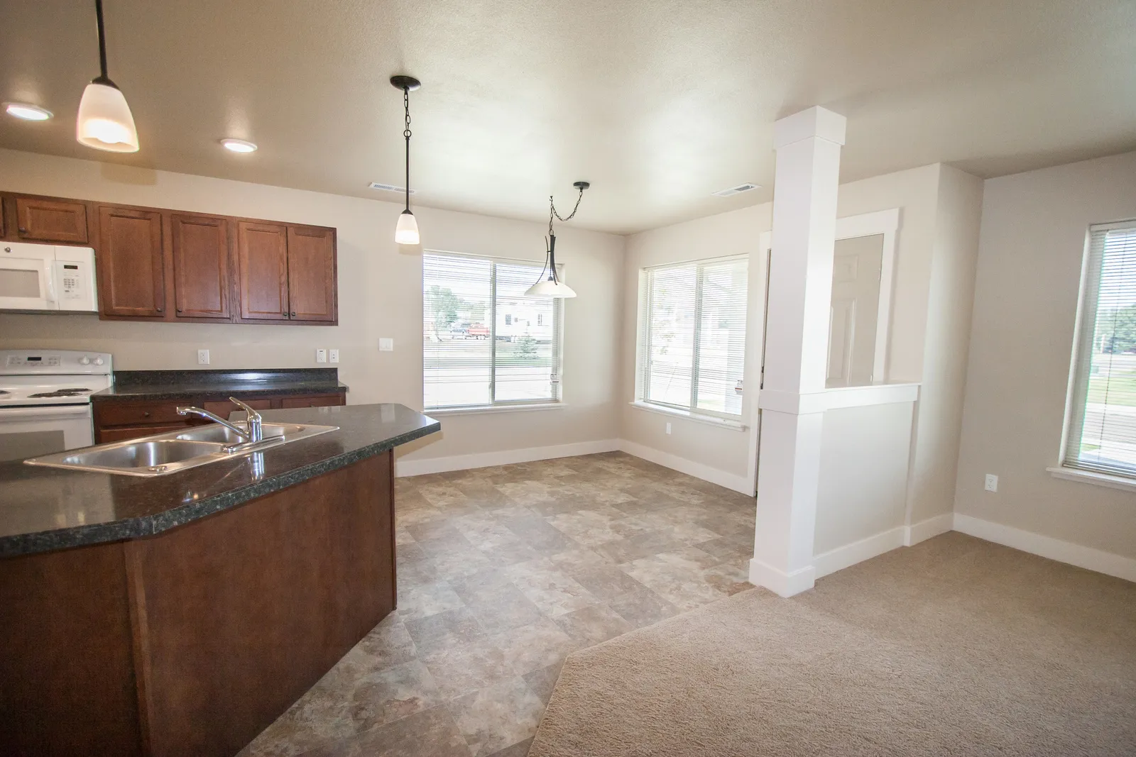 Bright open-concept kitchen and living area with large windows and contemporary finishes.
