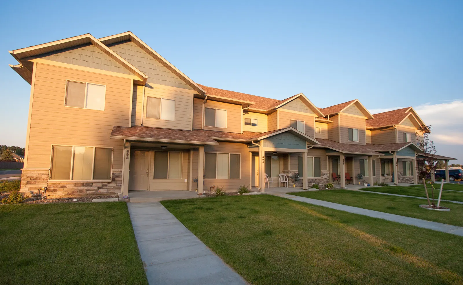 Beautiful multi-family housing with well-maintained lawns and walkways.