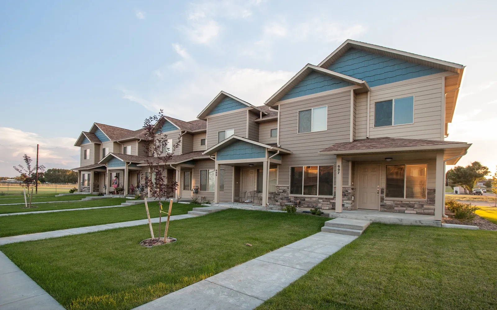 Apartment complex with well-maintained lawns, walkways, and contemporary architecture.