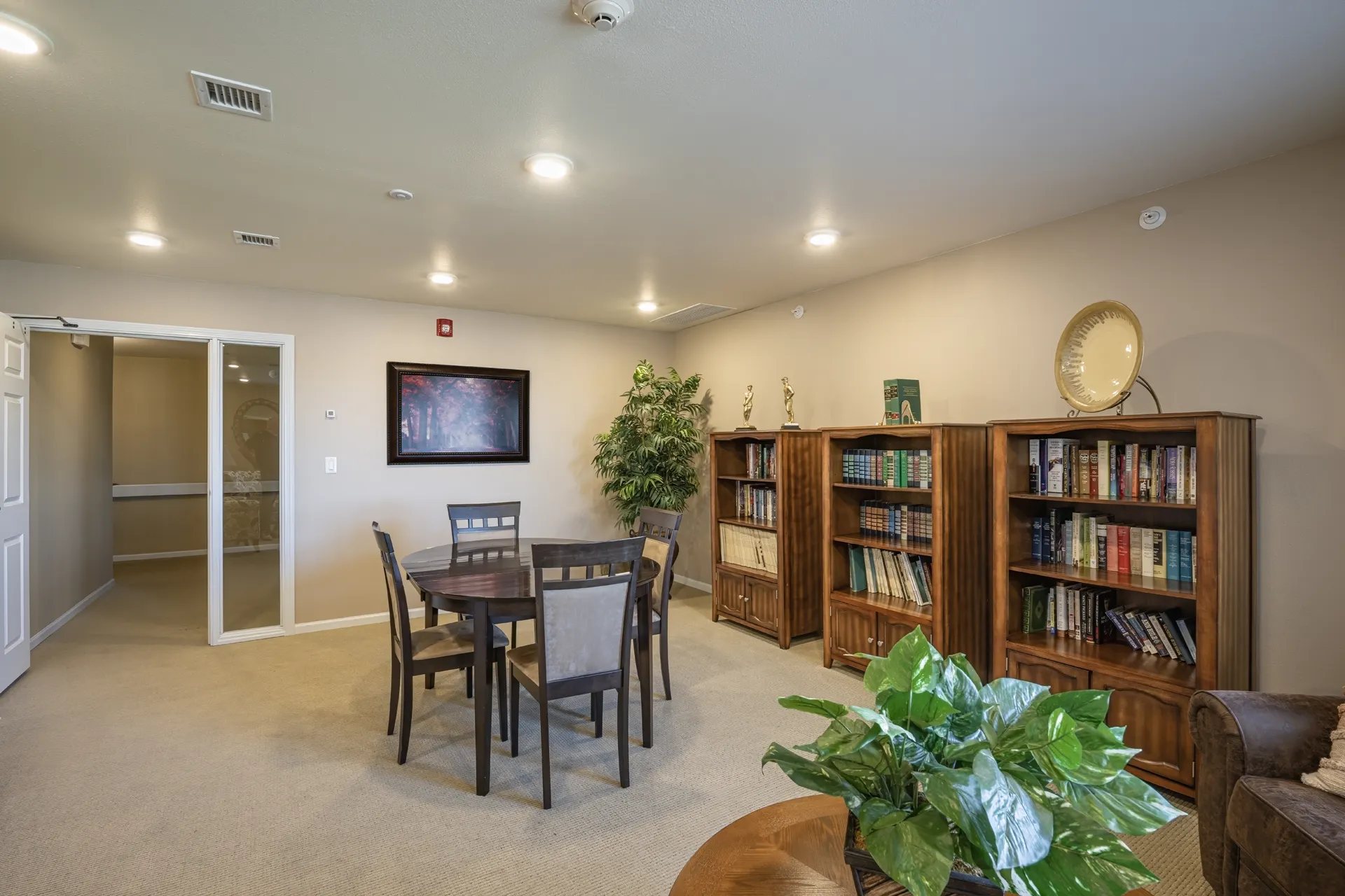 Interior lounge with bookshelves, seating, and decor at CR Builders.