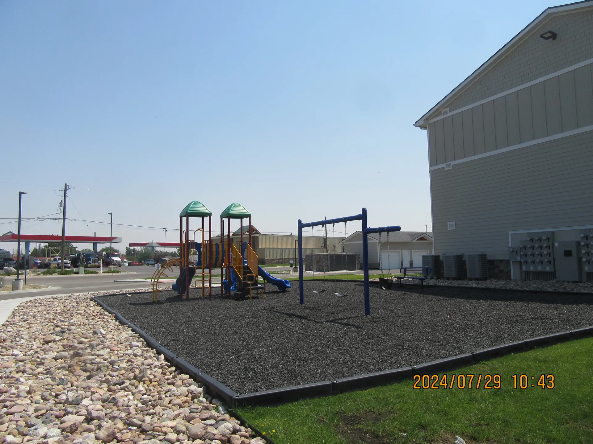 Playground with safety surfacing and colorful equipment for children.