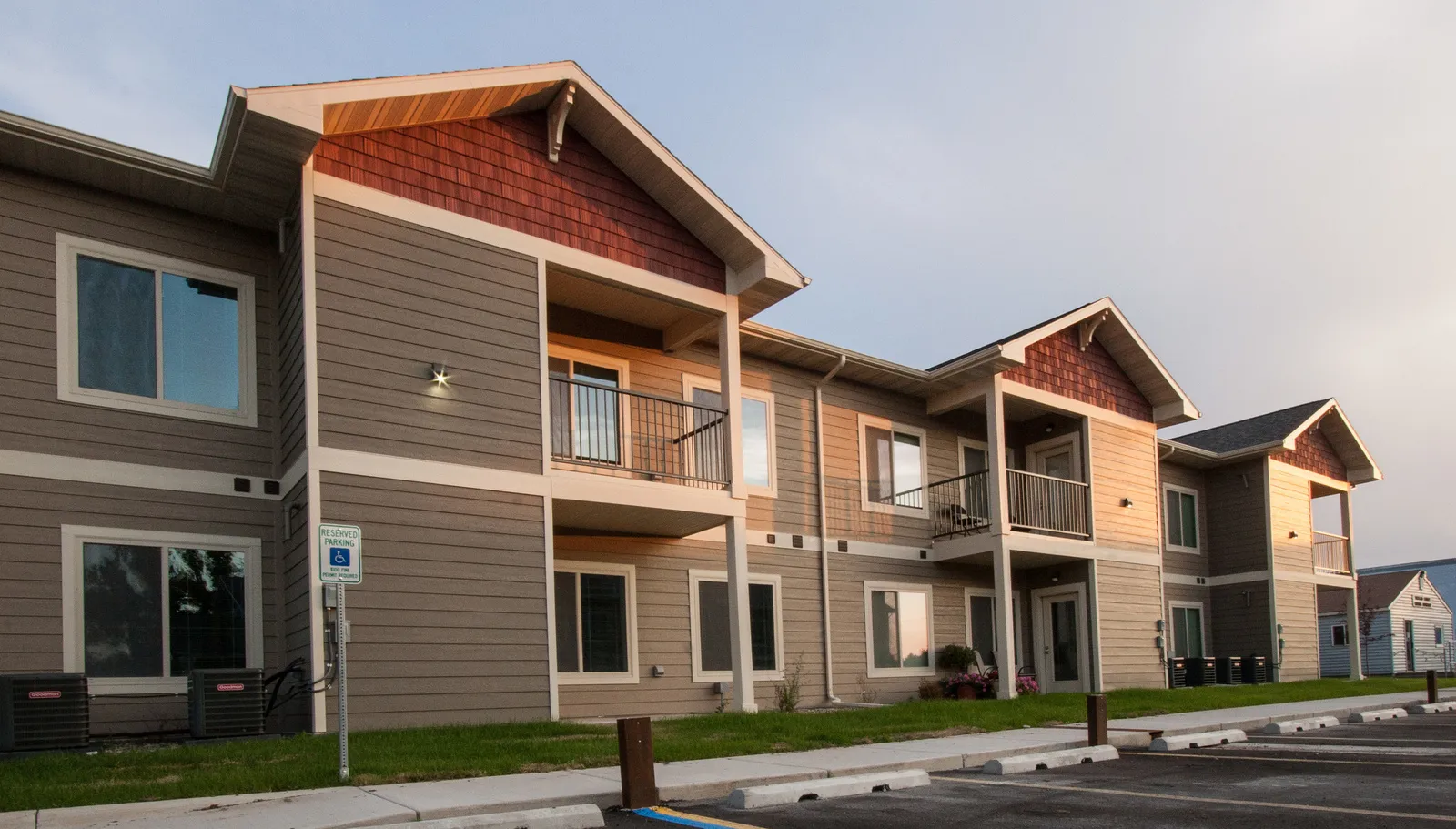 Contemporary multi-family apartment complex with balconies and large windows.