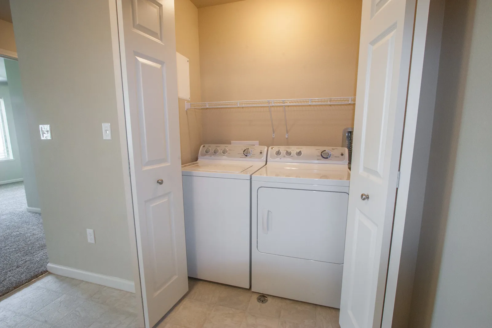 Washer and dryer in a compact laundry closet for efficient space use.