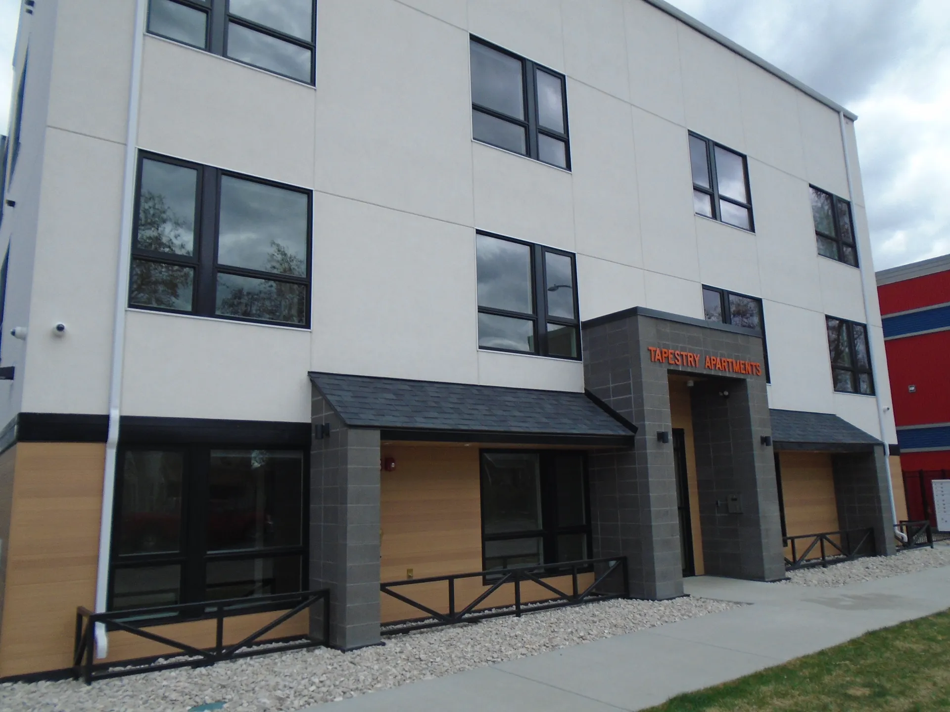Modern apartment building with large windows and contemporary architecture.